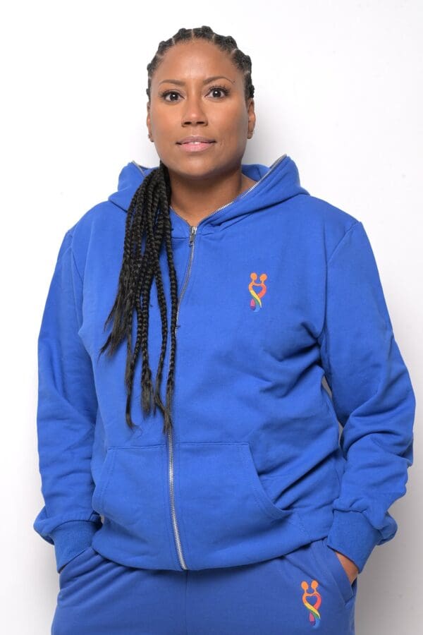 A person wearing a blue hoodie with long dreadlocks.