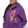 A woman wearing purple hoodie with rainbow heart and love is love on it.